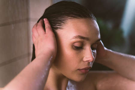 lifestyle moments of a young woman at home. Woman taking a shower in the morning