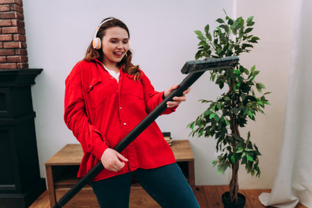 lifestyle moments of a young woman at home. Woman cleaning the apartment upの写真素材