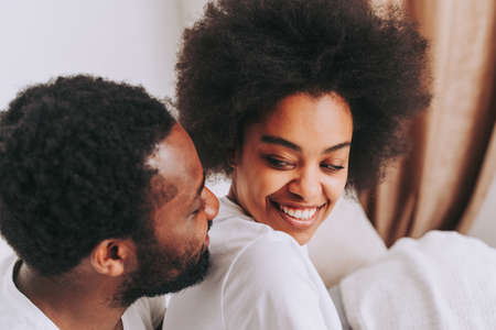 Afro american couple in bed - Real beautiful and cheerful pair of lovers at home