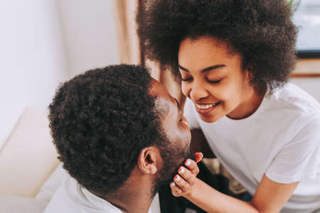 Afro american couple in bed - Real beautiful and cheerful pair of lovers at homeの写真素材