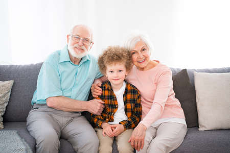 Grandparents and grandson playing at home - Family at home, grandmother and grandfather taking care...