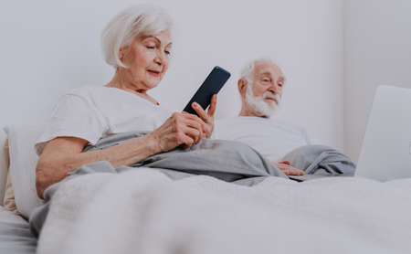 Beautiful senior couple enjoying time together at home - Moder elderly couple surfing the internet...