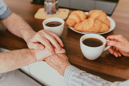Senior couple having breakfast at home - Elderly people daily life in the moningの写真素材