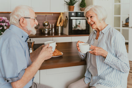 Senior couple having breakfast at home - Elderly people daily life in the moningの写真素材