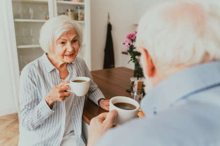 Senior couple having breakfast at home - Elderly people daily life in the moningの写真素材