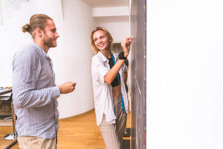 Multiethnic team of fashion designers working in a clothing start-up workshop - Multiracial group of stylists, tailor designers and dressmakers working on a new collectionの写真素材