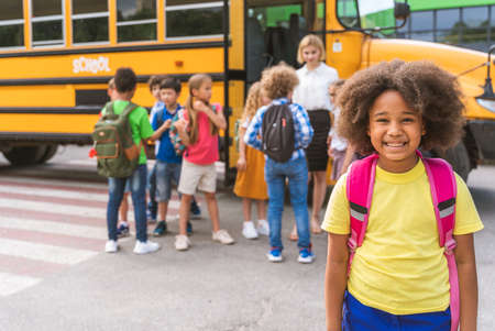 Group of young students attending primary school on a yellow school bus - Elementary school kids ha1ving funの写真素材