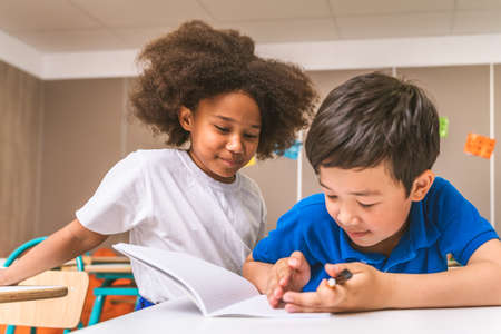Multiracial group of kids at primary school - Playful schoolers enjoying school time and lesson with...