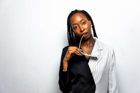 Beautiful afro-american woman with afro pigtails hairstyle and stylish clothes - Portrait of young...
