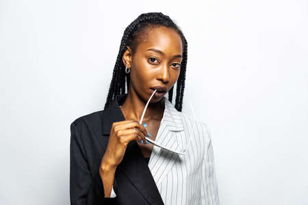 Beautiful afro-american woman with afro pigtails hairstyle and stylish clothes - Portrait of young black girl in studioの写真素材