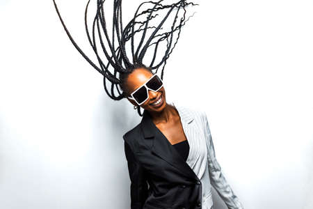 Beautiful afro-american woman with afro pigtails hairstyle and stylish clothes - Portrait of young black girl in studioの写真素材
