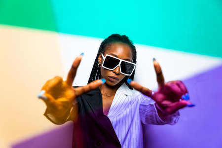Beautiful afro-american woman with afro pigtails hairstyle and stylish clothes - Portrait of young...