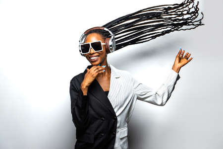 Beautiful afro-american woman with afro pigtails hairstyle and stylish clothes - Portrait of young black girl in studioの写真素材