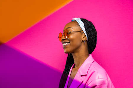 Beautiful afro-american woman with afro pigtails hairstyle and stylish clothes - Portrait of young black girl in studioの写真素材
