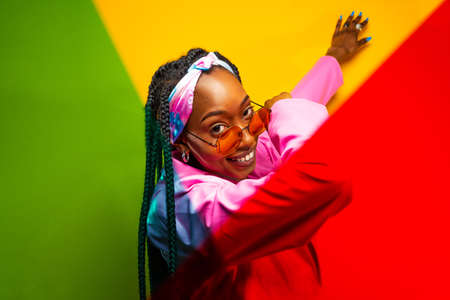 Beautiful afro-american woman with afro pigtails hairstyle and stylish clothes - Portrait of young...