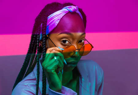 Beautiful afro-american woman with afro pigtails hairstyle and stylish clothes - Portrait of young black girl in studioの写真素材