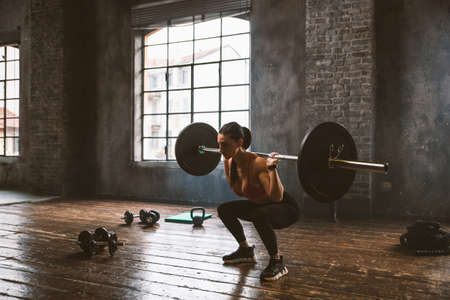 Beautiful woman training and making functional workout in the gymの写真素材