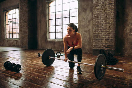 Beautiful woman training and making functional workout in the gymの写真素材