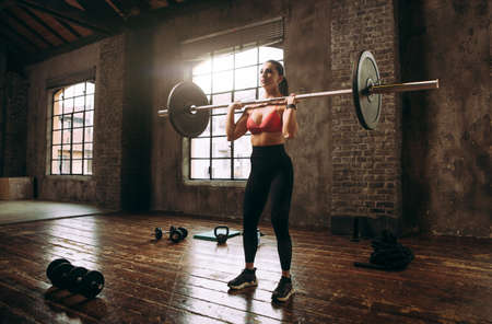 Beautiful woman training and making functional workout in the gymの写真素材