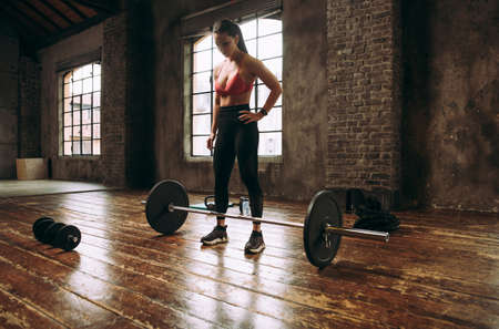 Beautiful woman training and making functional workout in the gymの写真素材
