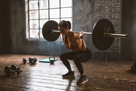 Beautiful woman training and making functional workout in the gymの写真素材