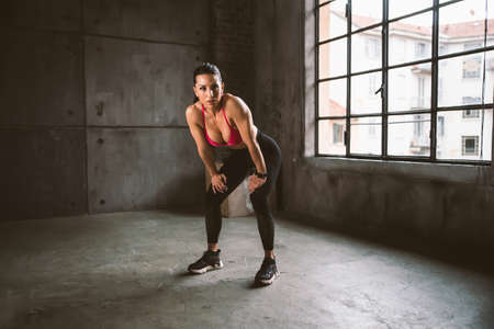 Beautiful woman training and making functional workout in the gymの写真素材