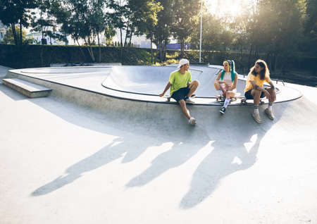 professional skateboarders having fun at the skate parkの写真素材
