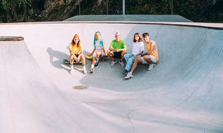 professional skateboarders having fun at the skate parkの写真素材