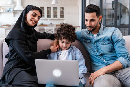 Happy family spending time together. Arabian parents and kid lifestyle moments at homeの写真素材