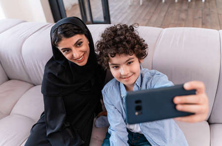 happy family spending time together. Arabian parents and kid lifestyle moments at homeの写真素材