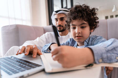 happy family spending time together. Arabian parents and kid lifestyle moments at homeの写真素材