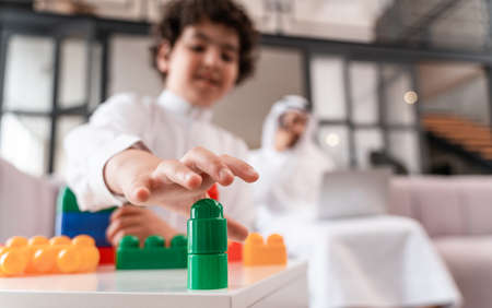 happy family spending time together. Arabian father and his son making different activities at homeの写真素材