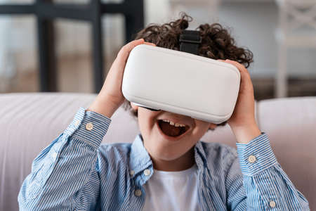 little kid using vr glasses. Concept about childhood and technology