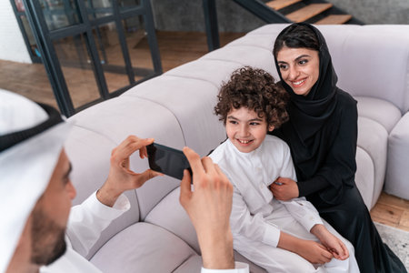 happy family spending time together. Arabian parents and their son playing and making different activities at homeの写真素材