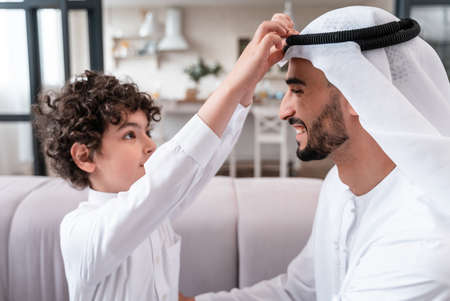 happy family spending time together. Arabian father and his son preparing to go to schoolの写真素材