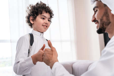 happy family spending time together. Arabian father and his son preparing to go to schoolの写真素材