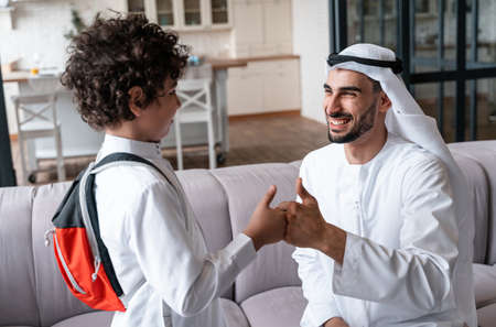 happy family spending time together. Arabian father and his son preparing to go to schoolの写真素材