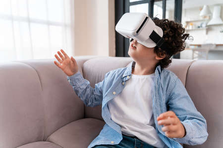 Little kid using vr glasses. Concept about childhood and technology