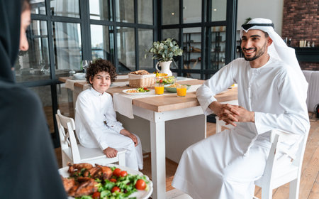 happy family from arab united emirates eating together and celebrating the national day holidaysの写真素材