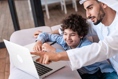 happy family spending time together. Arabian parents and kid lifestyle moments at homeの写真素材