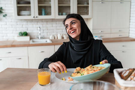 happy family from arab united emirates eating together and celebrating the national day holidaysの写真素材