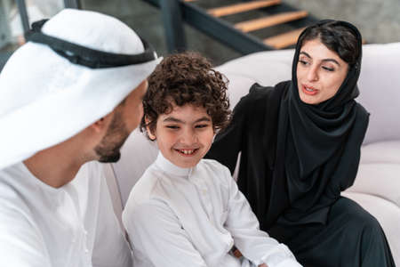 happy family spending time together. Arabian parents and their son playing and making different activities at homeの写真素材