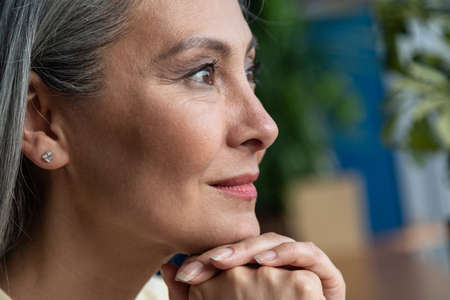 cinematic image of a senior business woman. Portrait of an employee in her officeの写真素材