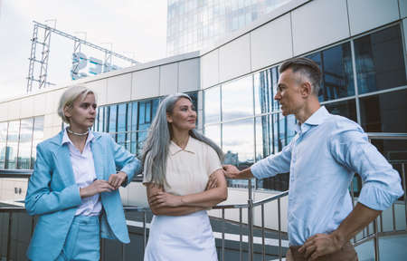 cinematic image of a multiethnic business team. employees speaking together on the balcony during the breakの写真素材