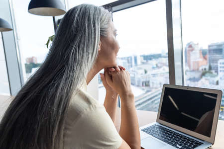 cinematic image of a senior business woman. Portrait of an employee in her office