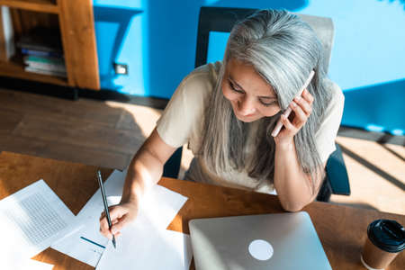 cinematic image of a senior business woman. Portrait of an employee in her office