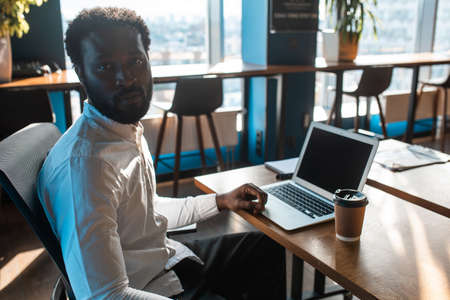 cinematic image of a young beautiful business man. Portrait of an employee in his officeの写真素材
