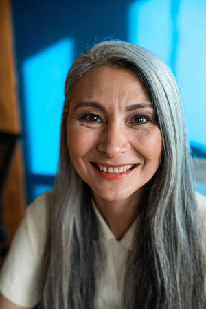 cinematic image of a senior business woman. Portrait of an employee in her office
