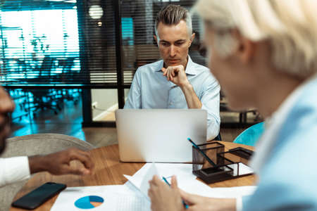 cinematic image of a multiethnic business team. employees working together in a modern officeの写真素材