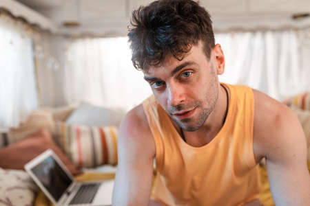 young man on vacation with the camper. Traveling with the autocaravan. Concept about wanderlust road...